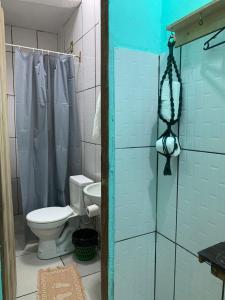a bathroom with a toilet and a shower at Pousada Conexão in Itaúnas +75 photos