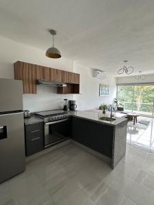 a kitchen with a refrigerator and a stove top oven at Apartamento con acceso directo al río in Veracruz