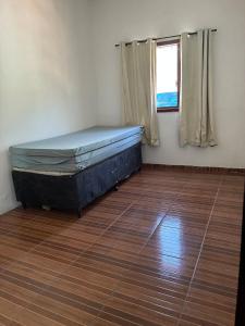 a room with a bed in a room with a window at Casa com 2 quartos in Cabo Frio