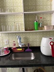 a kitchen counter top with a sink and a counter top at Casa com 2 quartos in Cabo Frio