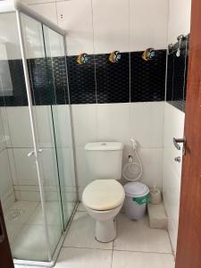 a bathroom with a toilet and a glass shower at Casa com 2 quartos in Cabo Frio +24 photos