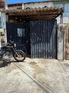 a motorcycle parked in front of a garage at Casa com 2 quartos in Cabo Frio