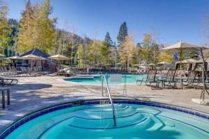 a pool at a resort with chairs and umbrellas at Everline Suite w/ Resort Perks! 7 Mi to Lake Tahoe in Olympic Valley