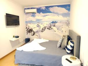 a bedroom with a mountain mural on the wall at Casa Dos Passos in Guarda