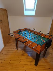 a foosball table in the middle of a room at Ferienhaus Mitteldachstetten, ruhige Lage, kostenlos parken, WLAN free in Oberdachstetten