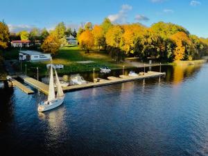 a boat is docked at a dock on a lake at Ośrodek TVP Sarnówek in Szałkowo