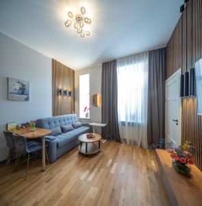 a living room with a blue couch and a table at Premium Design, Renovated 2024 Free parking in Riga
