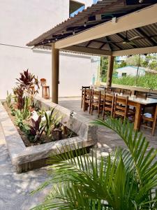 a patio with a table and chairs under an umbrella at Cabanas Villa Antonella Covenas in Coveñas