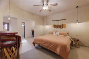 a bedroom with a bed and a ceiling fan at Hotel Hondo in Los Barriles +42 photos