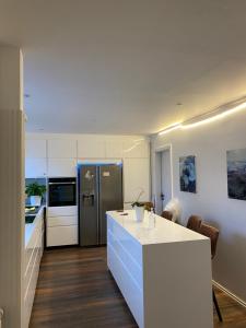 a kitchen with a white counter and a refrigerator at Easy Stay in Keflavík