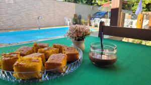 a plate of food on a table with a plate of cake at Pousada Flor do Campo in Serra do Cipo