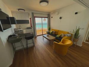 a living room with a couch and a table at Lev Yam Suite in Netanya