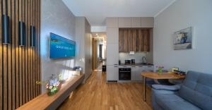 a living room with a blue couch and a kitchen at Premium Design, Renovated 2024 Free parking in Riga