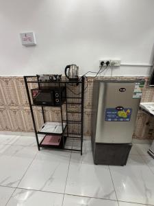 a refrigerator in a kitchen with a table next to it at مرافئ in Medina