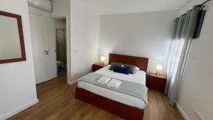 a bedroom with a bed with two towels on it at Amazing Blue House in Ribeira Grande