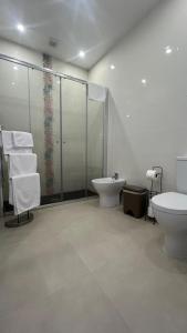 a bathroom with a shower and a toilet and a sink at Amazing Blue House in Ribeira Grande +11 photos