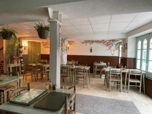 a restaurant with tables and chairs in a room at P&R hostals Maria Rosa in Tossa de Mar