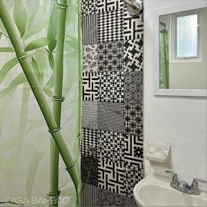a bathroom with a black and white tile wall at Casa Bamboo in Mexico City +79 photos