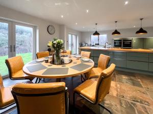a kitchen and dining room with a table and chairs at Achandoilach House in Strathcarron +22 photos