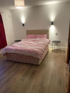 a bedroom with a large bed and a table at 12A Benbulben View in Bundoran