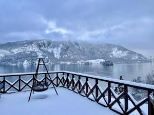 a view of a body of water with snow covered mountains at FjordCabin Preikestolen in Strand