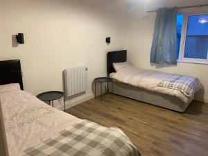 a room with two beds and a window at 12A Benbulben View in Bundoran