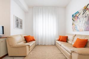 a living room with two leather couches and a television at Appartamento Corso Italia 269 in Sorrento +13 photos