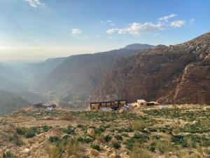 a view of a mountain with a house on a hill at Dana Trail Nomad Camp in Dana