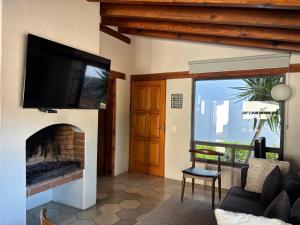 a living room with a fireplace and a flat screen tv at Hotel Boutique Unico Avandaro in Valle de Bravo