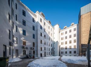 a row of white buildings with snow on the ground at Premium Design, Renovated 2024 Free parking in Riga