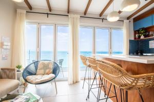 a living room with a view of the ocean at DelMare At Buye Beach Rooftop in El Cerro
