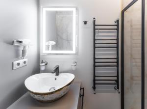 a bathroom with a bowl sink and a towel ladder at Premium Design, Renovated 2024 Free parking in Riga +19 photos