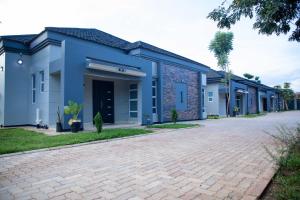 a building with a brick driveway in front of it at Phokera Homes in Lilongwe