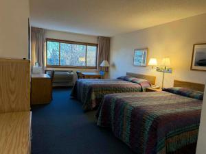 a hotel room with two beds and a window at Aspen Lodge in Croftville