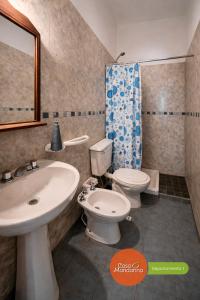 a bathroom with a white sink and a toilet at Casa Mandarina San Luis in La Punta +10 photos