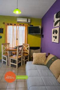 a living room with a couch and a table at Casa Mandarina San Luis in La Punta