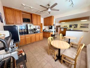 a kitchen with wooden cabinets and a table and chairs at The Shoreline Inn in Grand Marais