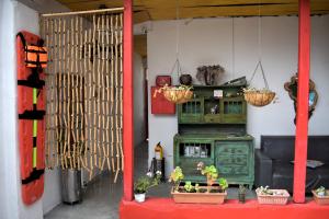 a living room with a green cabinet and some plants at El Hostal del Abuelo in Murillo