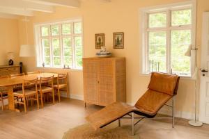 a kitchen and dining room with a table and chairs at Red Stone House By Dueodde Beach in Neksø