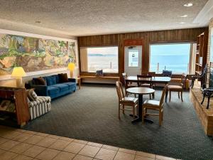 a living room with a blue couch and a table at The Shoreline Inn in Grand Marais