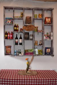 a shelf on a wall with bottles of wine at El Hostal del Abuelo in Murillo +73 photos