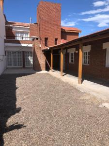a brick building with a driveway in front of it at House beach in Puerto Madryn