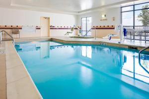 a large swimming pool with blue water at SpringHill Suites by Marriott Cheyenne in Cheyenne