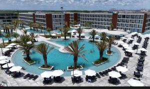 an overhead view of a pool with palm trees and umbrellas at Porto 2 live in Porto De Galinhas +7 photos