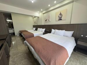 a hotel room with two beds and a television at Hotel Coronado in Tacna +38 photos