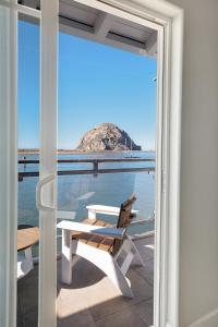 a room with a view of the ocean from a balcony at Anderson Inn in Morro Bay