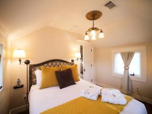 a bedroom with a bed with two towels on it at RedTail Inn - 3 Suites Sleeps up to 12 in Ashland