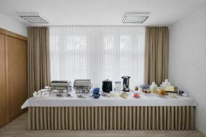 a table with food on it in front of a window at Ośrodek TVP in Ciechocinek