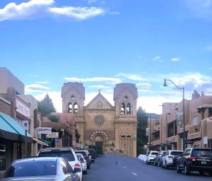 a street with cars parked in front of a church at Serenity in Santa Fe