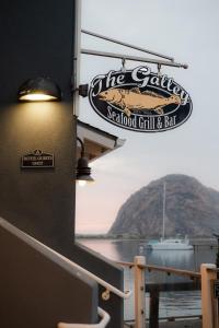 a sign for a seafood grill and bar on a boat at Anderson Inn in Morro Bay